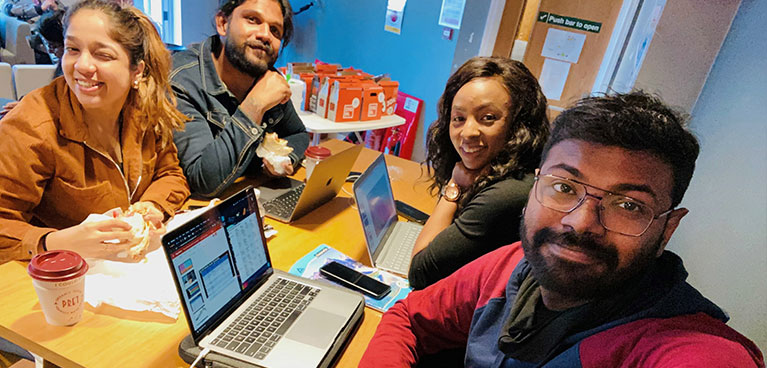 Perin and his friends doing their assignments in the student lounge