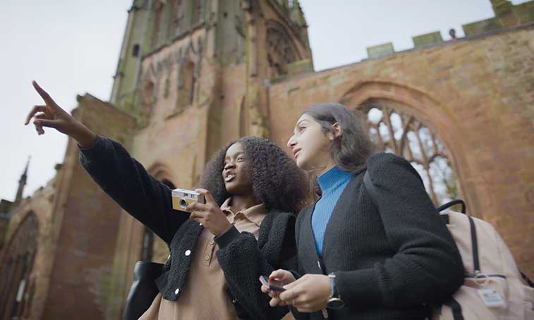 group of friends exploring Coventry cathedral ruins