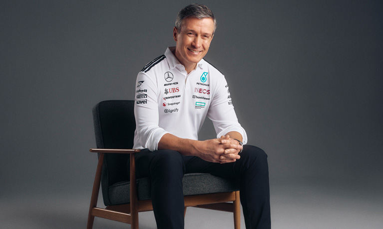 Rob Thomas sat in a chair in a Mercedes team shirt