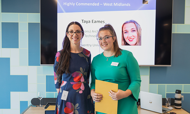 Taya Eames and Joy Woods winning an award