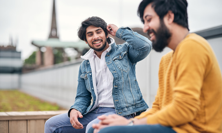 Two students sitting outside 