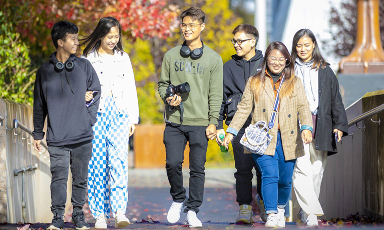 A group of international students walking on campus