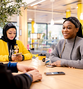 Students talking around a table