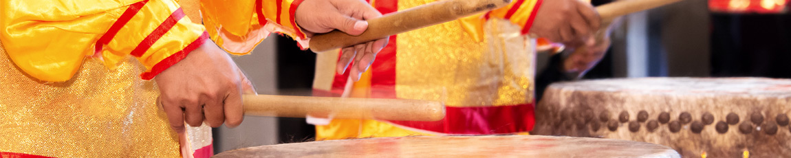 Chinese ceremony drummers in yellow silk robes.