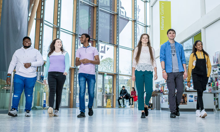 Group of six students walking in the Herbert Gallery