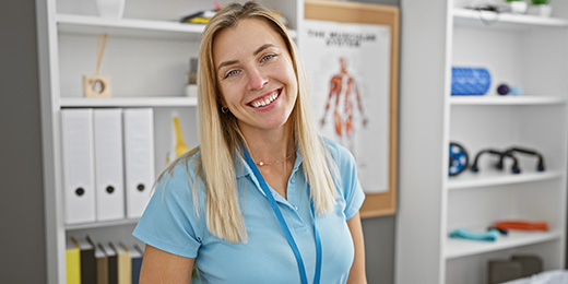 An Occupational Therapist in her unifrom smiling at the camera