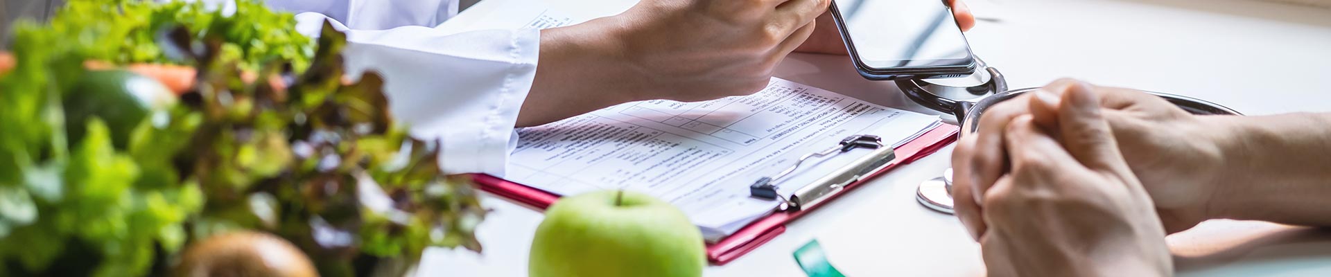 Paperwork and a bowl of fruit in a Dietitians office