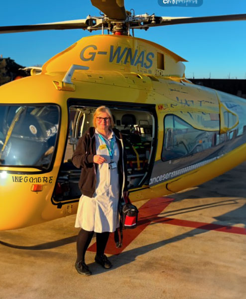 A man sitting down and smiling