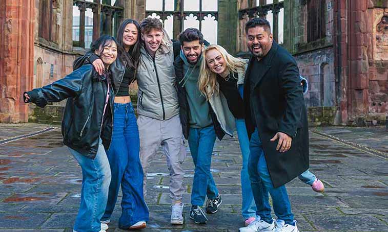 Group of students standing in the Cathedral ruins 
