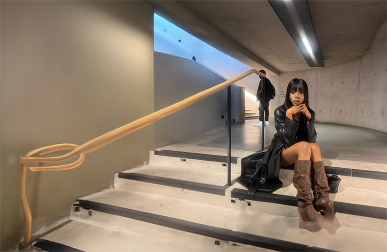 Laura Onome Momodu sitting on a shallow set of steps