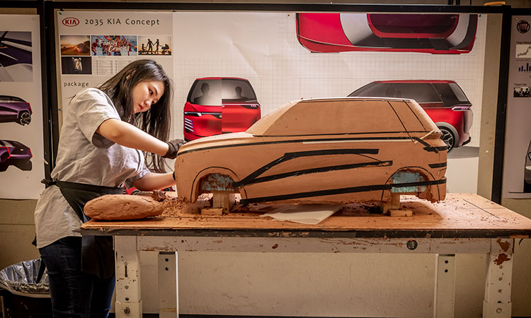 Female student creating a clay model in the clay studio at Coventry University.