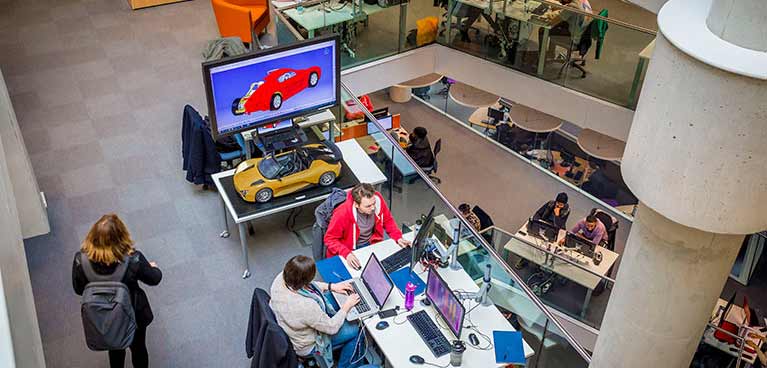 A birds eye view of students working on computers at desks in Informal study areas