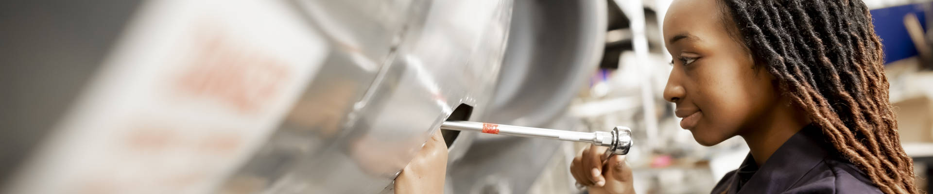 a woman working on a airplane in a Coventry University engineering building