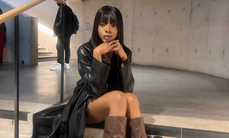 Image of Laura sitting on a stairwell 