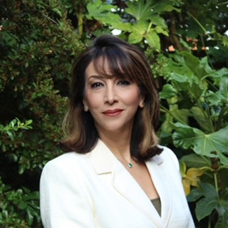 Headshot of Dr Hany Wells smiling at the camera