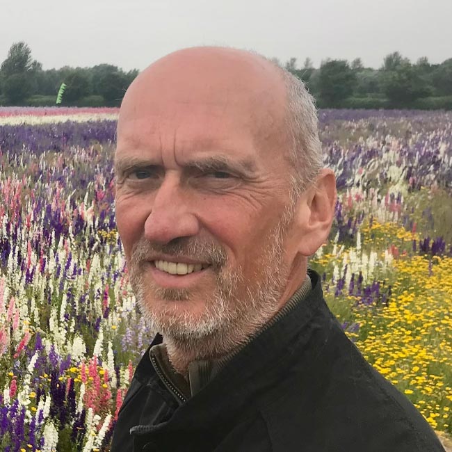 Headshot of Ian Davidson in a field of flowers