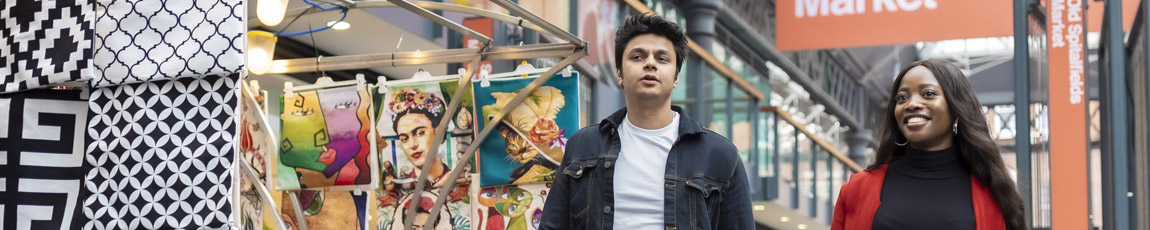 Two students walking through the Old Spitalfields Market.