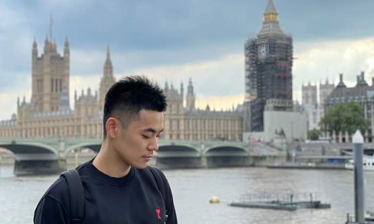 head shot of student Zhu Panchen with London city skyline in the background