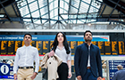 Three young people in Liverpool station carrying luggage 