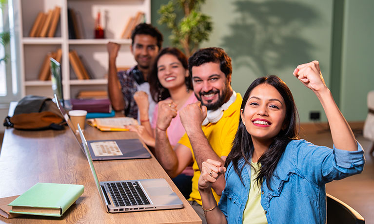 four students sat cheering