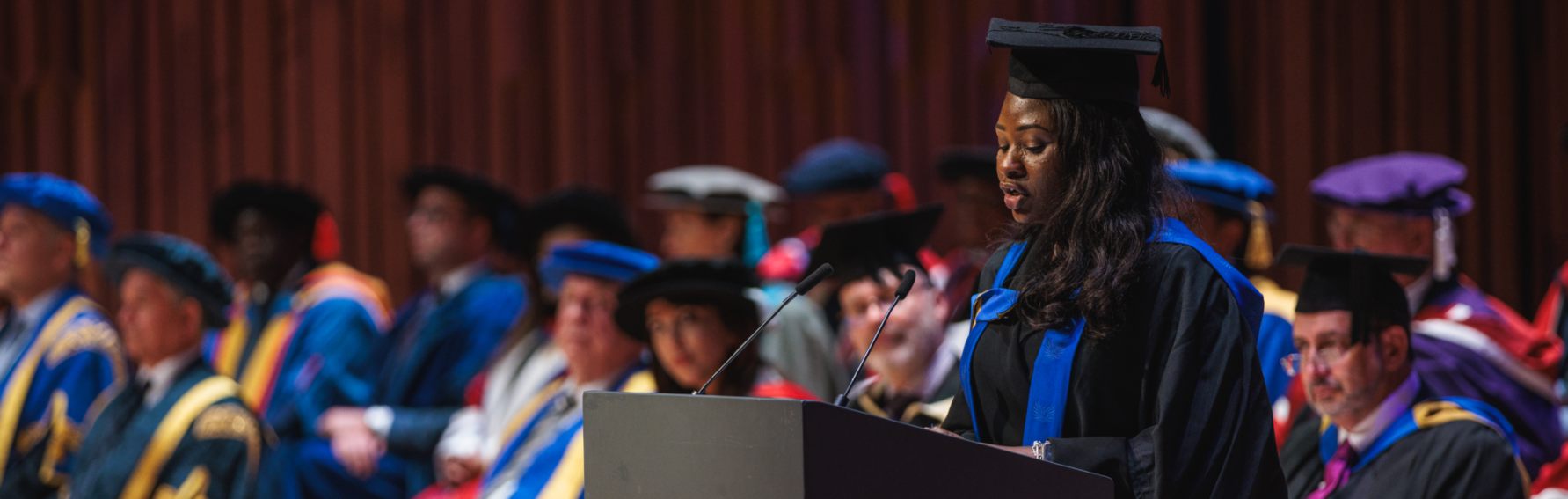 Graduate giving a speech at a podium