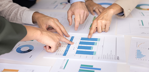 People pointing at bar charts