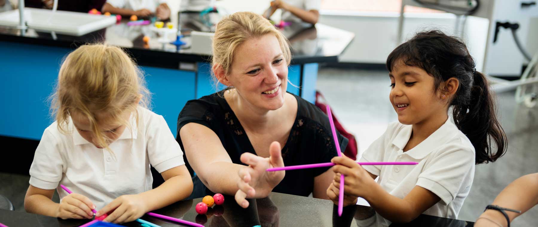 women teaching two kids