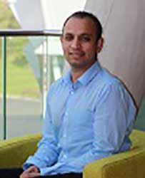 Portrait of Amit Bhatnagar sat on a chair