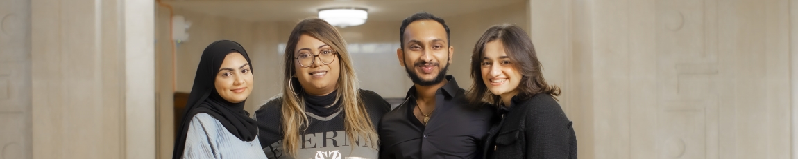 Head and shoulder shot of three females and one male student