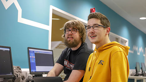 Two Computing Science students working at computers