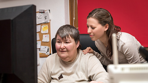 Female nurse attending a patient which is watching TV