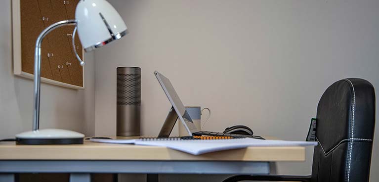 Desk with lamp and tablet and a desk chair