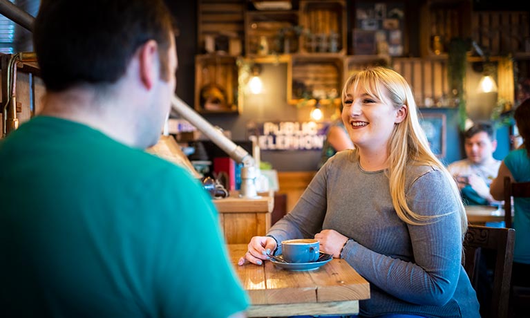 Two students sat with a coffee talking