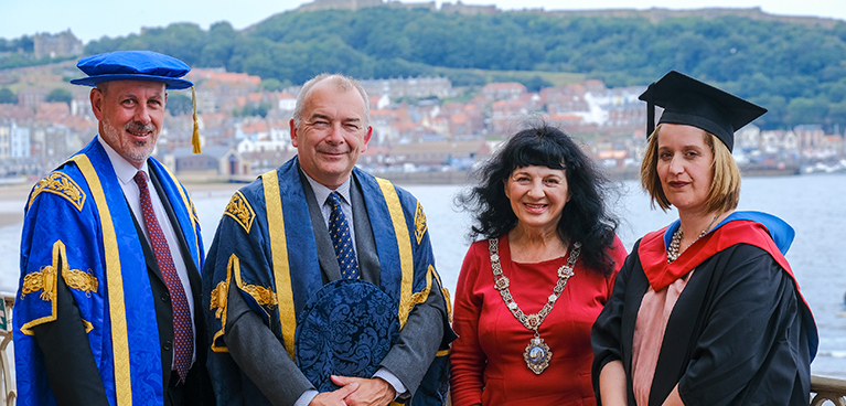 John Dishman, John Latham and Kay Fraser at the graduation ceremony