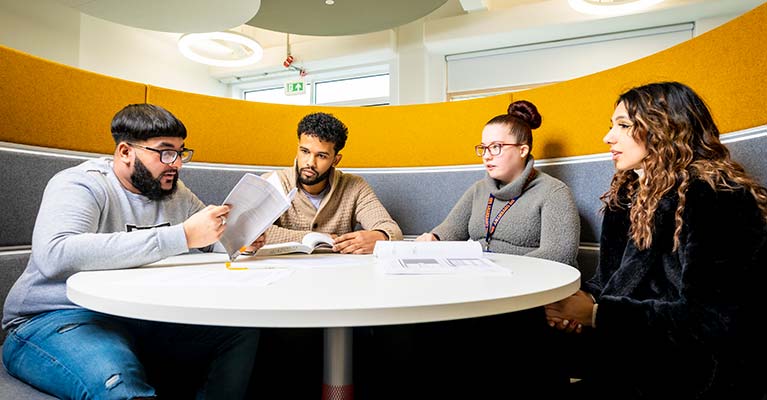 Group of students sat in a pod talking