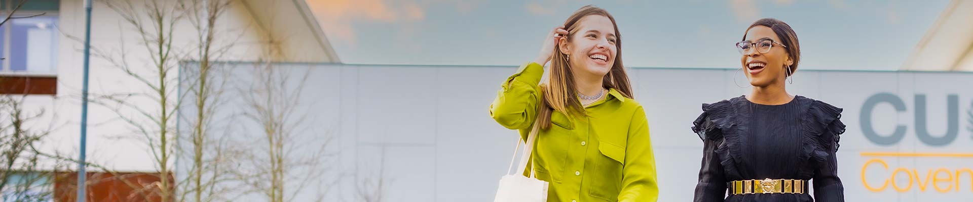 Two students walking away from Mile Lane