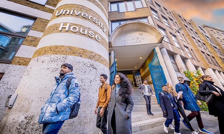 Students walking out of the University House building