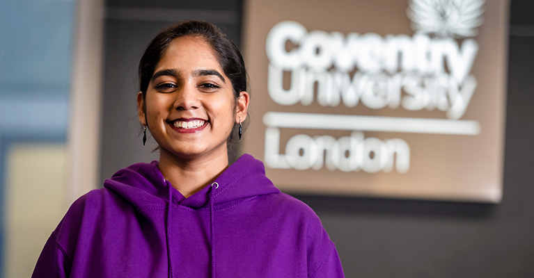 Smiling lady wearing a striking purple top