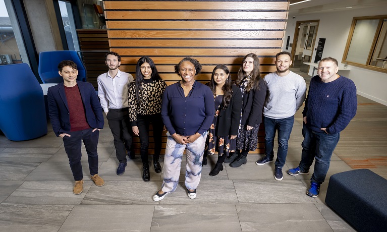 A group of Coventry University success coaches standing in the reception of a university building