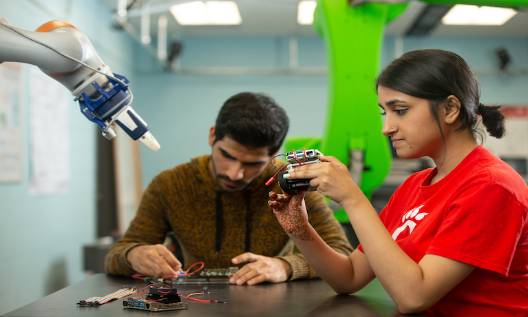 Students working with robotic equipment