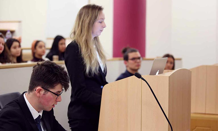 Law student practicing in the moot room