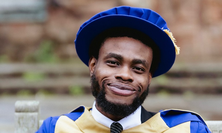 A head and shoulders image of Dr Emmanuel Johnson in a grasduation gown and cap