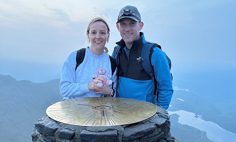 Ryan and Amy Jackson standing at the top of a mountain