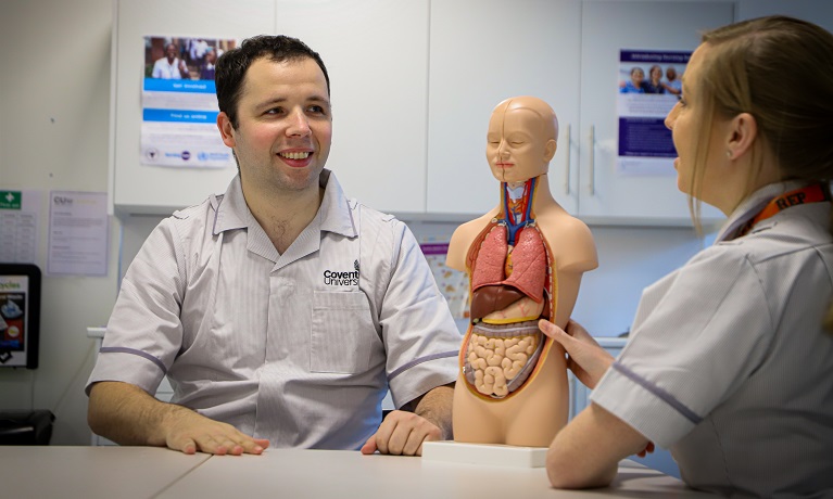 Two nursing students working on a mannequin 