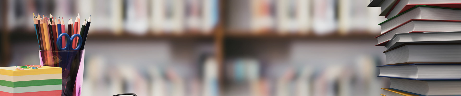 Glasses, post-it notes and coloured pencils in a pot on a desk with a bookcase in the background