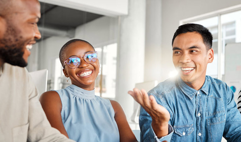 Andy McCall portrait with a laptop and a whiteboard behind
