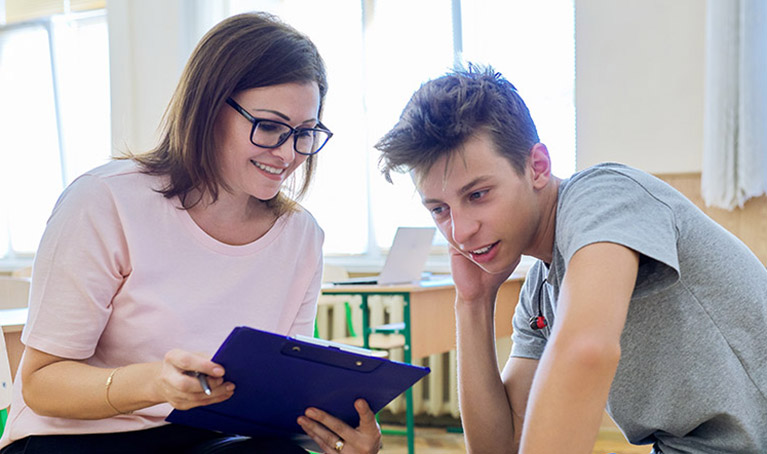 A teacher supporting a student