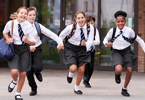 Schoolchildren running together.
