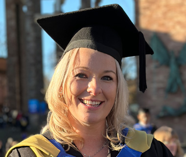 Amy Robinson in a cap and gown at her graduation ceremony.