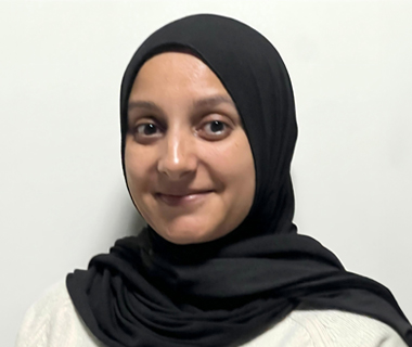 A headshot of Zakiya smiling